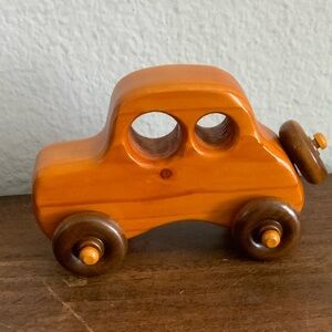 Orange Wooden Handmade Toy Car with Brown Wheels Sign